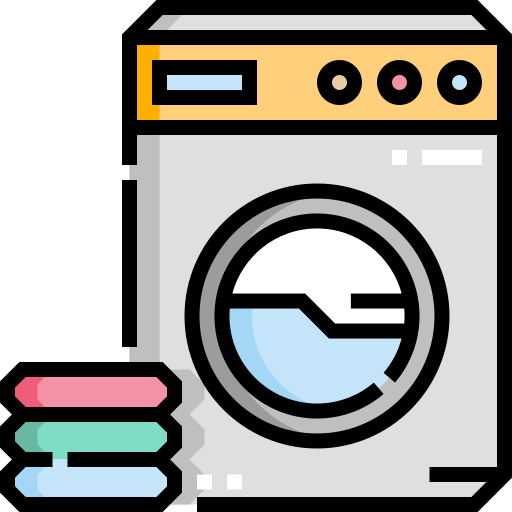A washing machine with a circular front door is shown next to a stack of folded clothes in green, pink, and blue.