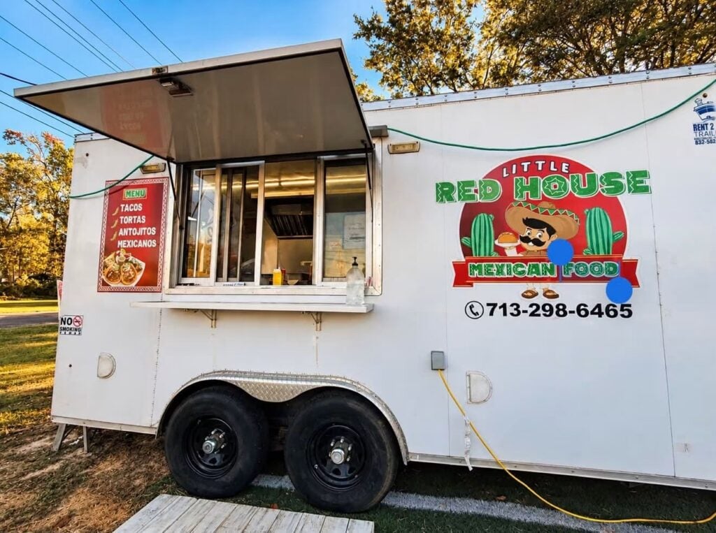 Little Red House Mexican food truck with a menu listing tacos, tortas, and antojitos, plus a phone number displayed on the side.